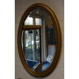 A giltwood oval wall mirror circa early 20th century,