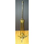 **An Art Nouveau brass telescopic floor lamp, with stylized leaf supports,