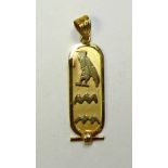 An Egyptian gold pendant, with hieroglyphic design to front, stamped with foreign marks, 4cm long,