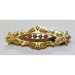 A 9ct gold Victorian brooch, set with four small gemstones to centre within foliate gold decoration,