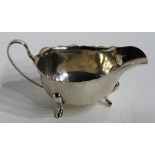 A silver sauce boat, hallmarks for Birmingham 1933 Adie Bothers, of plain design with frilly rim,