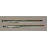 A boxed pair of silver Cross pens, of plain ribbed design,