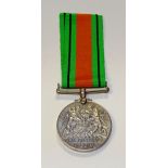 A World War II Defence Medal, on green and orange ribbon,