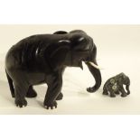 A large ebony elephant figure, with faux ivory tusks, 28cm high,