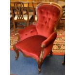 A Victorian mahogany framed gent's armchair, upholstered in later red buttonback velour,
