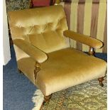 A mahogany framed low armchair in the style of Howard & Son, circa late 19th/early 20th century,