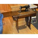 A vintage oak cased treadle Singer sewing machine,