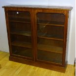 A Victorian mahogany bookcase, with two glazed doors enclosing shelved interior,