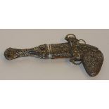 An Eastern white metal dagger, with brown leather back to scabbard ornately decorated,