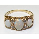 A gold opal and diamond ring,