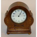 An Edwardian mahogany inlaid mantel clock, the white enamel dial with Arabic numerals,