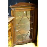 A reproduction mahogany hanging corner cabinet,