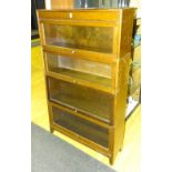 A vintage oak stacking bookcase by Gunn & Co, the four sections having pull up glazed doors,