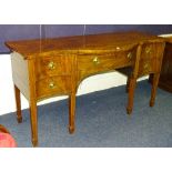 A Regency style mahogany inlaid serpentine sideboard circa 19th century, with a single drawer,