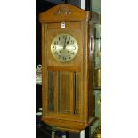 An oak wall clock circa 1930's, the silvered dial with Arabic numerals, lacking pendulum,