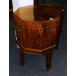 A George III mahogany octagonal wine cooler, with hinged top enclosing lead interior liner,