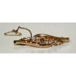 A yellow metal amethyst, seed pearl and paste brooch, stamped K19, 5.5cm long, 4.