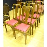 A set of six oak splat back dining chairs, with red cushion drop in seats,