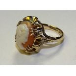 A 9ct gold cameo ring, carved with bust of a lady to shell, in tall, raised claw setting,