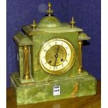 An onyx mantel clock, with cream enamel and gilded dial,