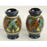 A pair of Gouda Rhodian pattern vases, in typical colours, stamped 1203 to underside,