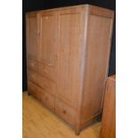 A large Art Deco light oak cupboard chest by Heals of London circa 1920/30's,