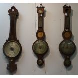 A 19th century rosewood wheel barometer, signed WM Gilbert, 15cm high, St Belfast to silvered dial,