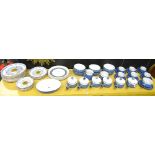 A part blue and white stoneware glazed dinner service, comprising one serving bowl, six large bowls,