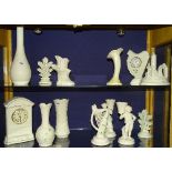 A quantity of modern Belleek porcelain, to include mantel clock, vases, figural posy vases,