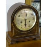 A walnut cased mantel clock, the silvered dial with Arabic numerals, striking on single chime,