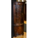 A reproduction corner cabinet,