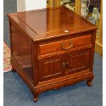 A Chinese hardwood bedside cupboard, with drawer above two panelled doors,