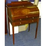 An Edwardian mahogany inlaid cylinder writing bureau, the sliding cover enclosing fitted drawers,