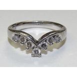 A platinum seven stone diamond wishbone ring, the round brilliant cut diamonds totalling 0.