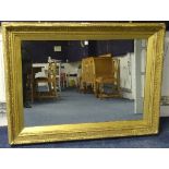 A large antique giltwood wall mirror,