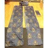 A pair of Art Nouveau style blue silk damask curtains, decorated with floral panels,