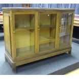 A large vintage oak partners display cabinet, with three glazed doors to each side,