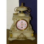 A white onyx mantel clock, the pink and white enamel dial with Roman numerals, pendulum present,