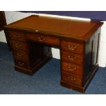 A mahogany kneehole desk, with leather inset above single drawer flanked with four small drawers,