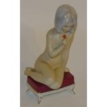 A Royal Dux figure of a nude lady, seated on footstool smelling a flower, no.