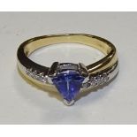 An 18ct gold tanzanite and diamond dress ring, the triangle cut tanzanite to centre approx. 0.