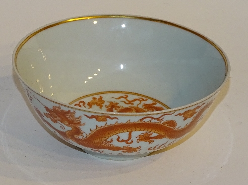 A Chinese dragon decorated bowl, with orange coloured panels and blue reign marks to underside,