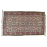 PERSIAN RUGthe central plain with all over leaf and floral decoration within a running floral and