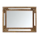 LARGE NINETEENTH-CENTURY BRASS FRAMED CUSHION MIRROR OVERMANTLEThe central rectangular plate