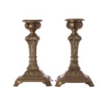 PAIR OF NINETEENTH-CENTURY ORMOLU CANDLESTICKSthe circular candle bowl supported on a square