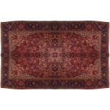 NORTH WEST PERSIAN HERIZ CARPET, CIRCA 1940on red ground, with blue border303 x 401 cm.