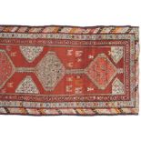 NORTH WEST PERSIAN RUNNER, CIRCA 1880on red ground, with ivory medallion264 x 90 cm.