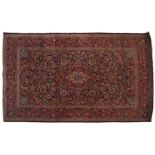 WEST PERSIAN KASHAN RUG, CIRCA 1920on navy ground with red border134 x 204 cm.