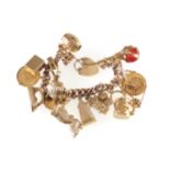 LADIES 9CT. ROSE GOLD GRADUATED CURB CHARM BRACELET with 17,9ct yellow gold charms, and a padlock