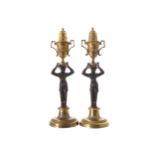 PAIR OF REGENCY PERIOD ORMOLU AND BRONZE FIGURE STEMMED CANDLE STICKS 30 cm. high (2)